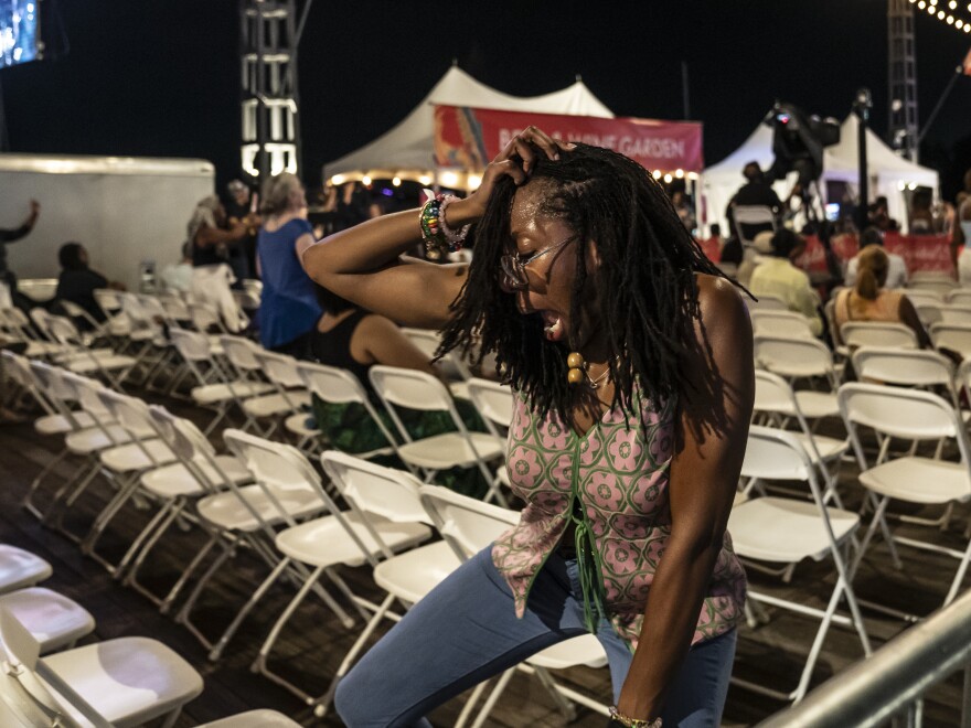 A festivalgoer enjoys the Chuck Brown Band at the District Pier during the DC JazzFest in Washington, D.C.